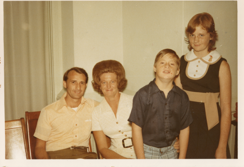 Seated man and woman pose with standing boy and girl