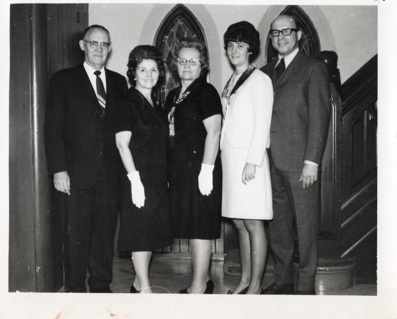 Two women and three men pose for a photograph