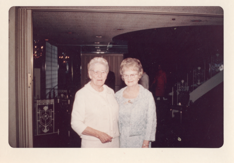 Two older women smile together