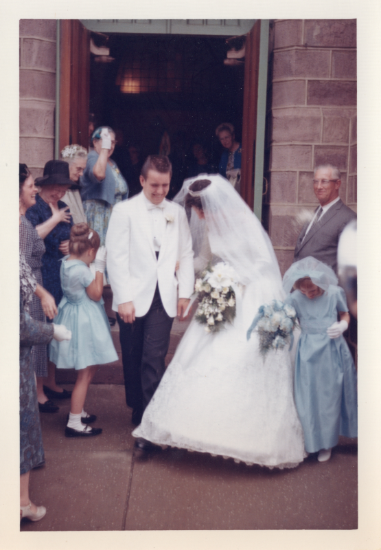 A bride is walked out of her wedding ceremony