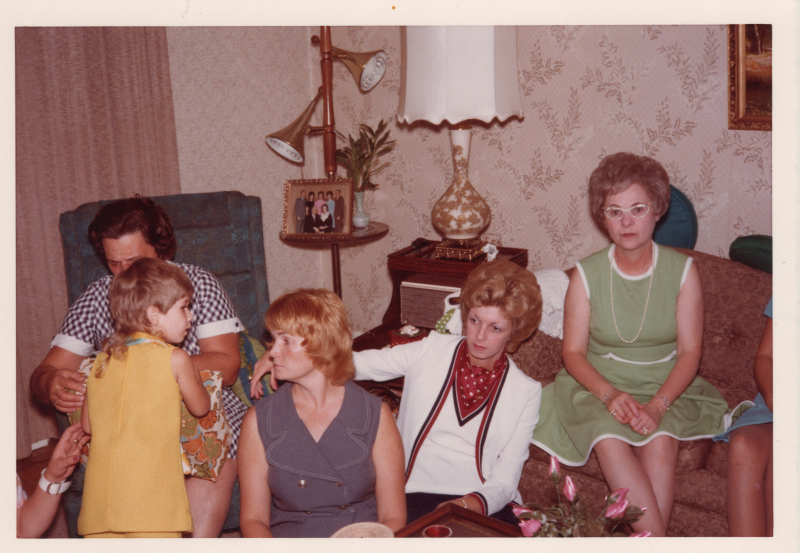 Four women seated with a young girl