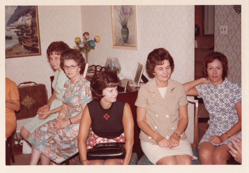 Five women seated at a celebration