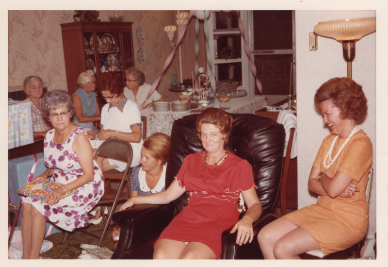 Women seated with wrapped presents and streamers