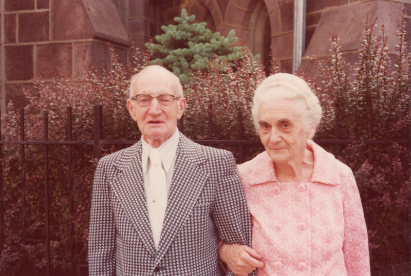 An older man and women lock arms outside of the building at 18th and Spring Garden streets