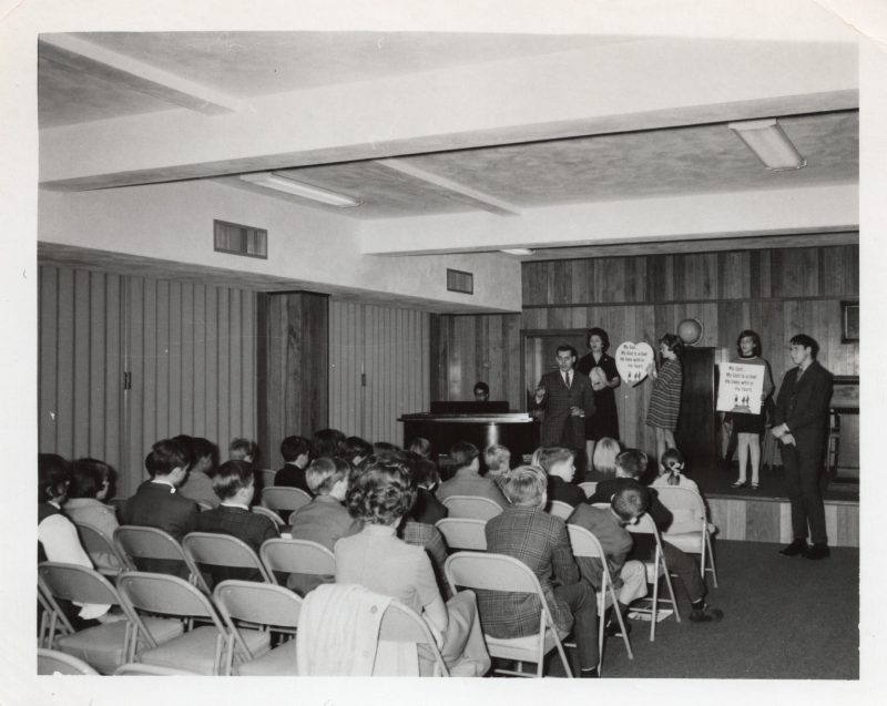Adult leaders lead worship for a child audience