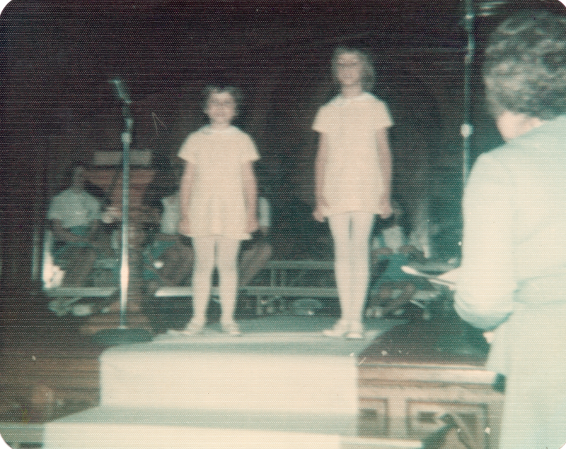 Two young girls perform on sanctuary stage