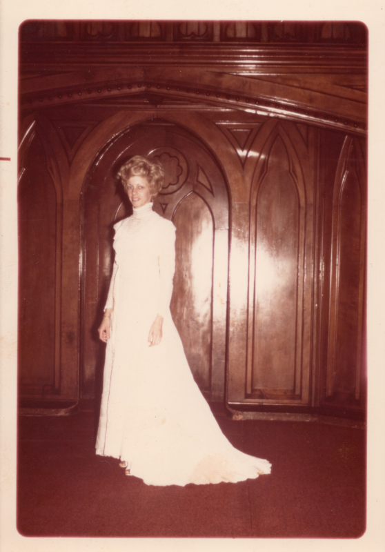 A young woman poses for a photo in the sanctuary in a wedding gown