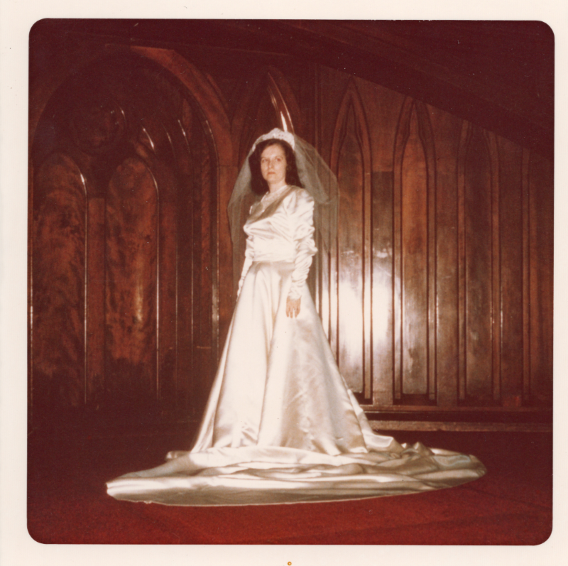 A woman poses on the sanctuary stage in a wedding gown