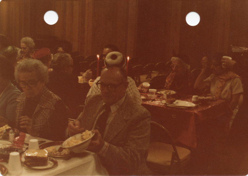 A man serves himself mashed potatoes
