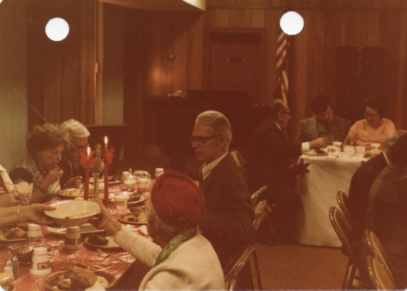 Congregants pass bowls of food