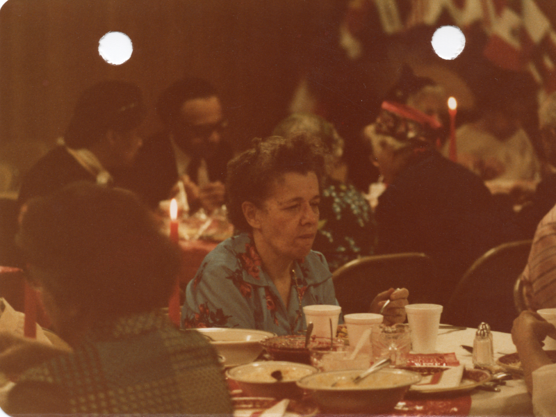 A woman eats soup