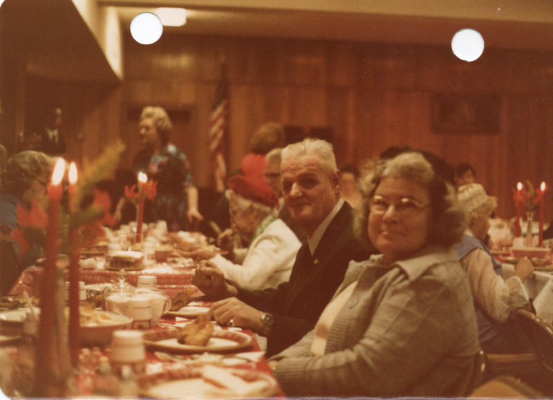 A dining man and woman smile for a photograph
