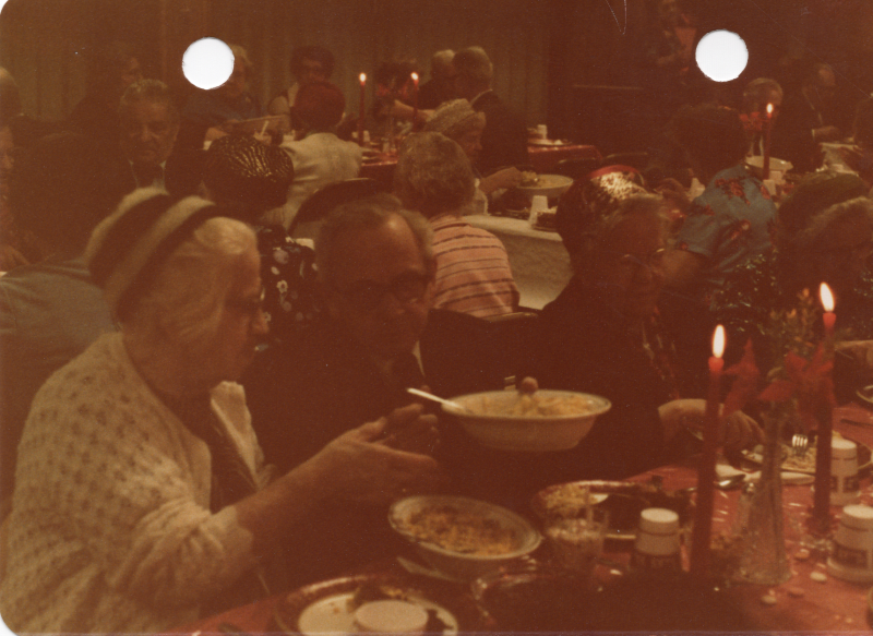 Congregants pass bowls of food