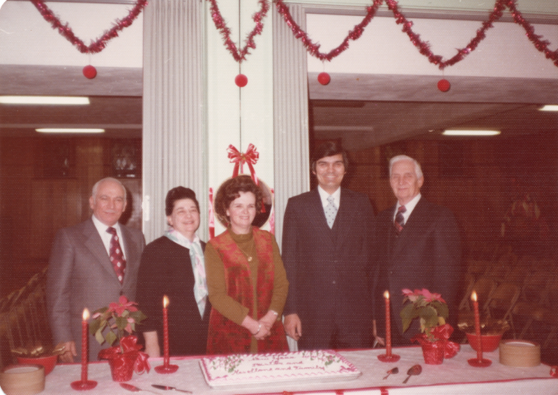 The Stones pose for a photograph with Pastor Roberson in front of a cake