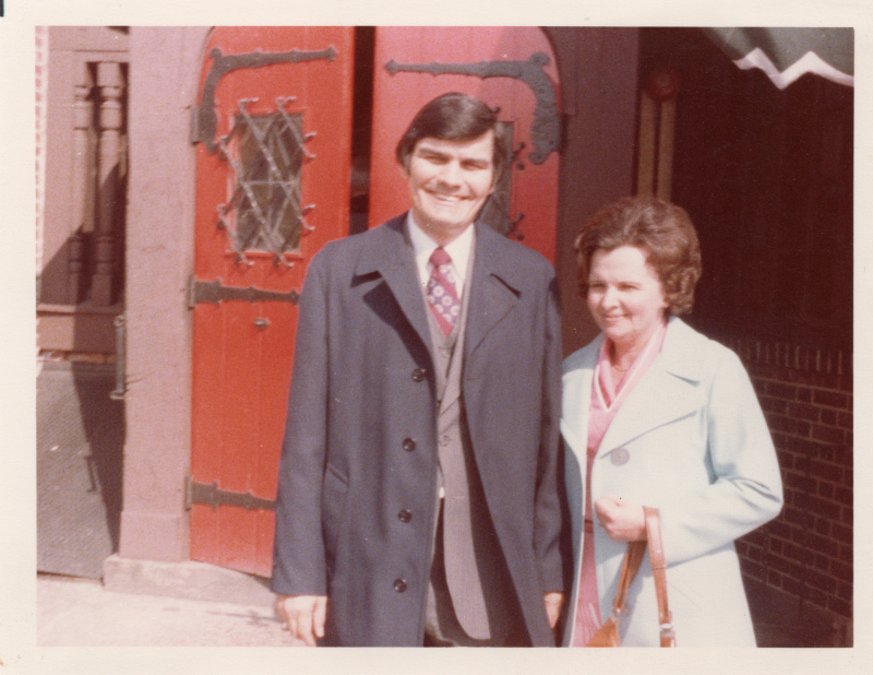 Pastor and Mrs. Stone pose together arm-in-arm