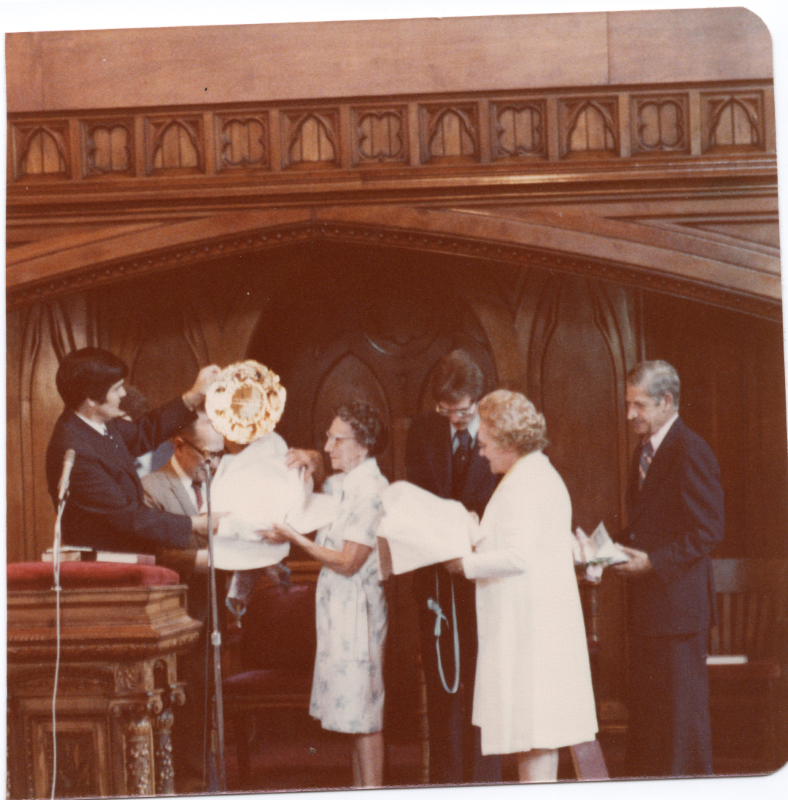 Pastor Stone is presented a gold plate on stage by members of the congregation