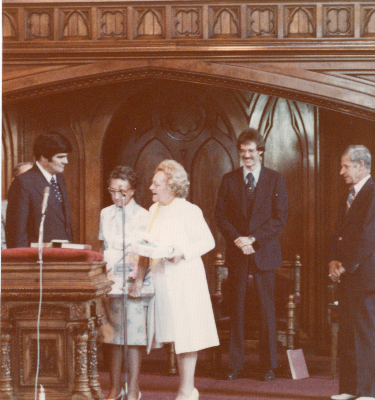 Pastor Stone speaks with the congregants who gave him a gold plate on stage in the sanctuary