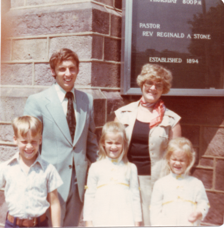 A man and woman pose with their son and two daughters