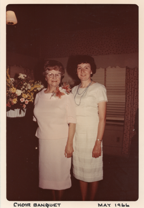 Two women smile for a photograph at a choir banquet