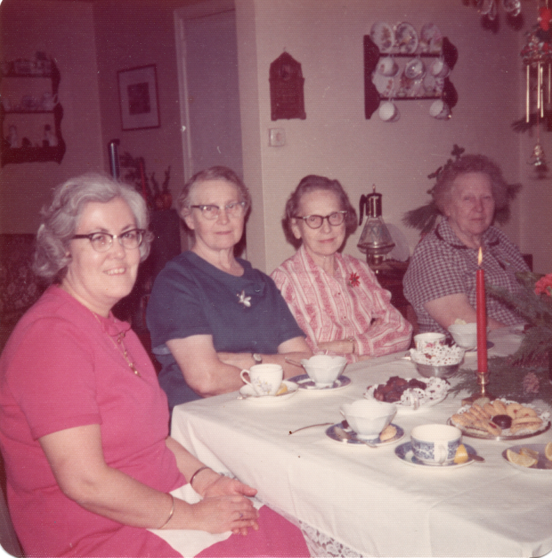 Four women smile for a photograph