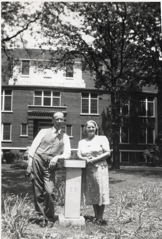 Pastor and Mrs. Bragg smile together outside