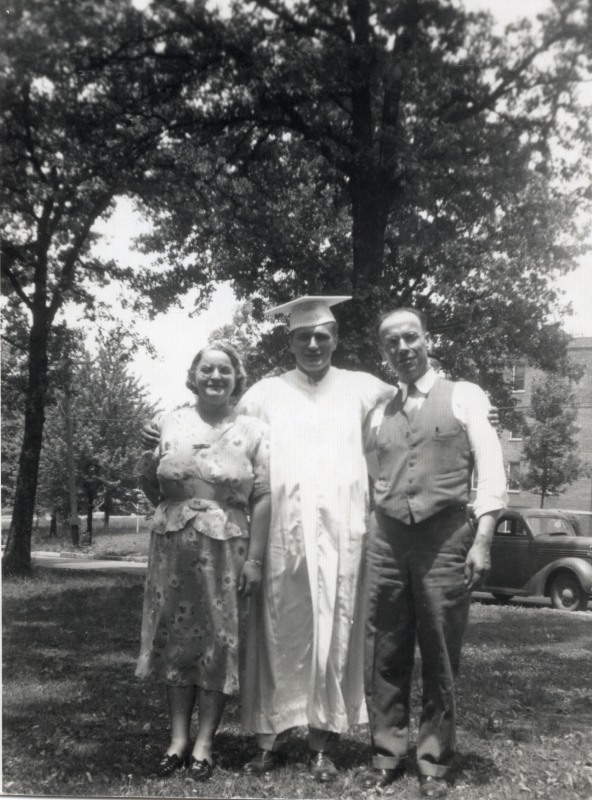 Pastor and Mrs. Bragg pose with Bob Schambach in his cap and gown