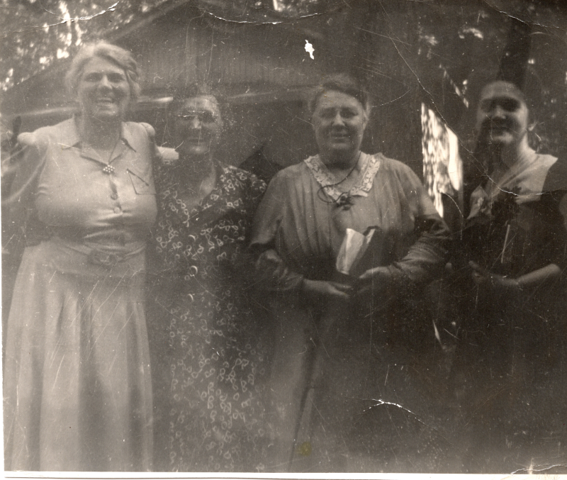 Four women smile for a photograph