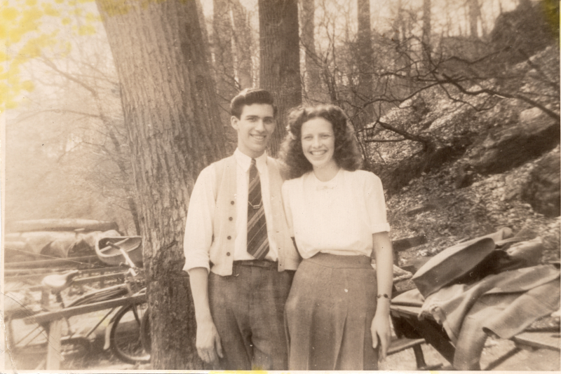 A man and a woman smile for a photograph outside