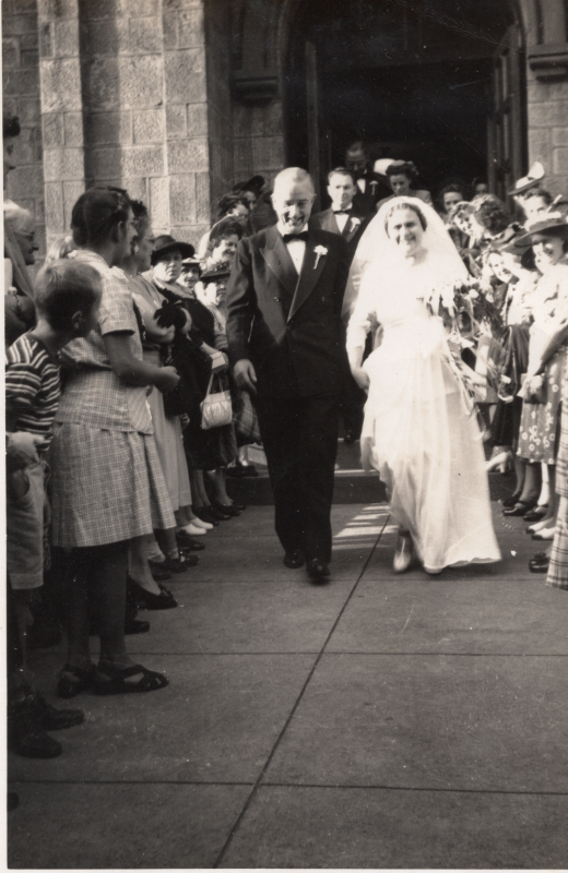 A bride walks out of the church at 19th and Green streets, arm-in-arm with a man in a tuxedo