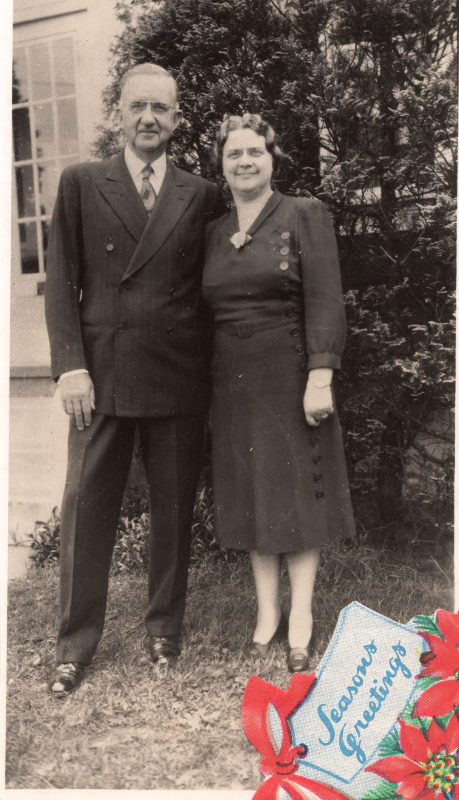 A couple smiles together for a Christmas photograph