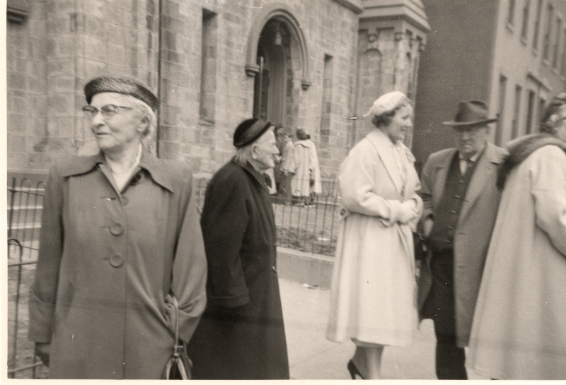Congregants mingle outside of the church at 19th and Green streets as they exit the building