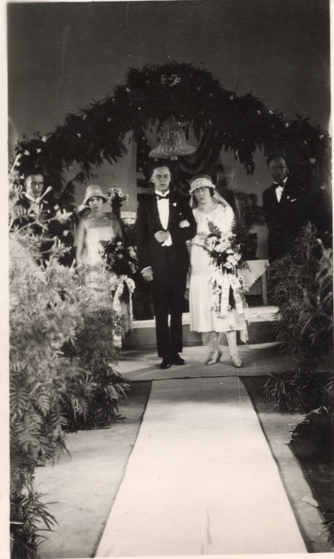 A bride and groom walk arm-in-arm down the aisle