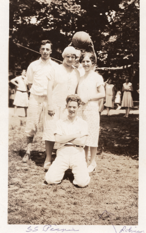 Fred and Gladys Hopeworth, Hester Laffery, and Bill Roberson smile together with a basketball on a field