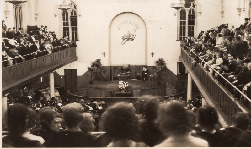 Photograph of the Highway congregation, the pulpit at 19th and Green streets, and the "Jesus Saves" Cross and Crown