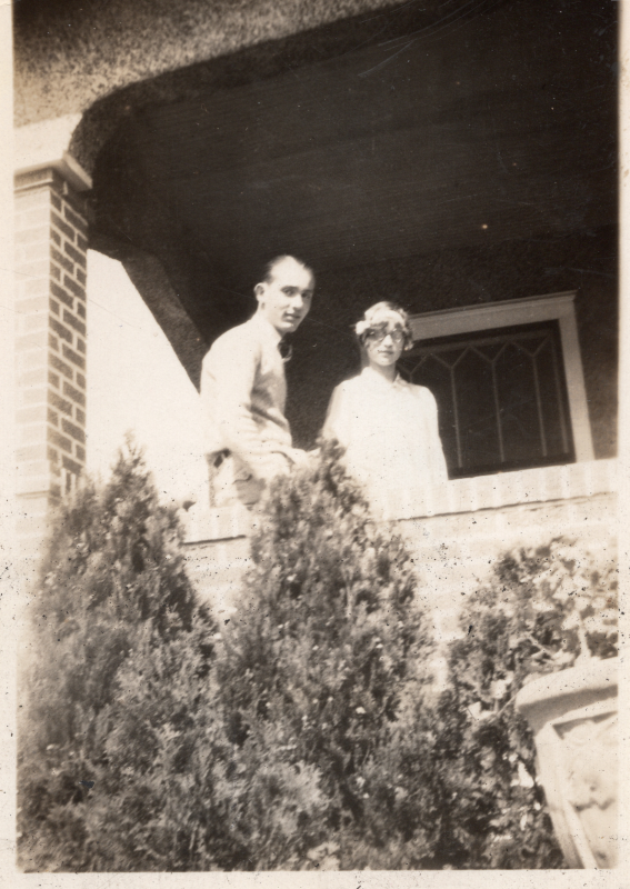 Man and woman stand together on a porch