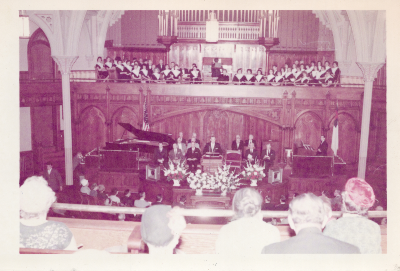The Highway Choir with an organist in the balcony and a group of men at the pulpit at the dedication of the church at 18th and Spring Garden Streets