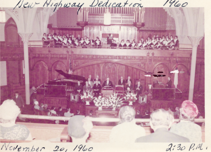 The Highway Choir with an organist in the balcony and a group of men at the pulpit at the dedication of the church at 18th and Spring Garden Streets