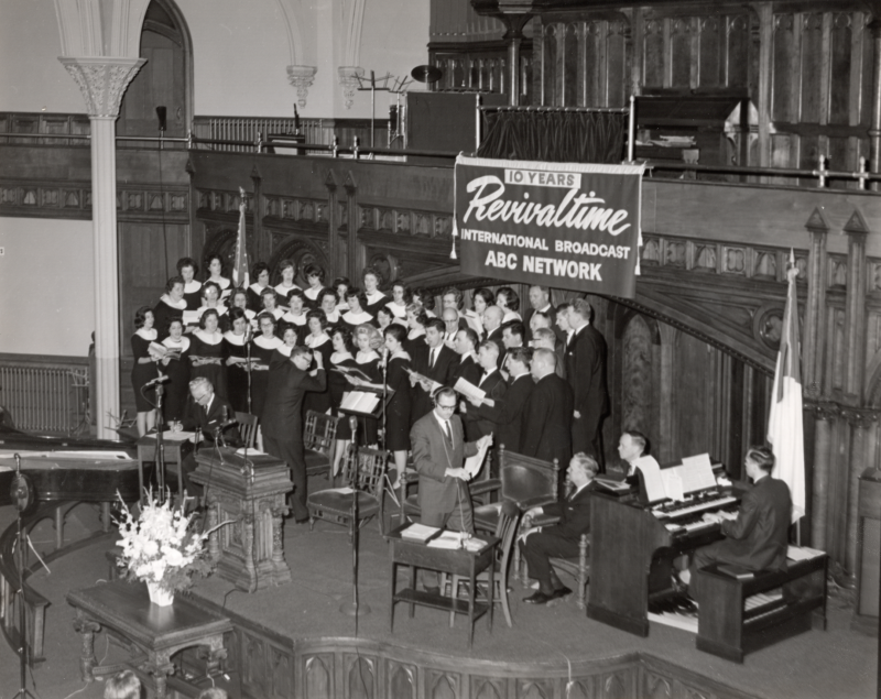 The Highway Choral Group performs with an organist for the Revivaltime radio broadcast in the sanctuary at 18th and Spring Garden Sts.