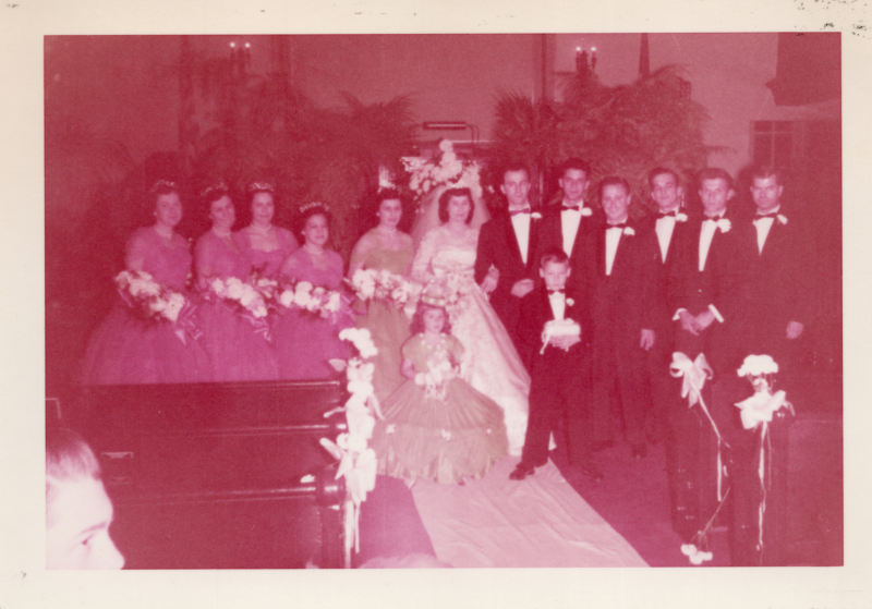 Valeria Bogdan standws with a bridal party in pink and green with Lawrrnce Cerrulo and his groomsmen in suits
