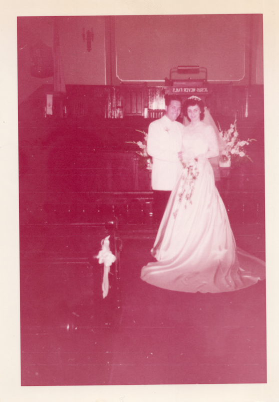 A bride and groom smile together for a portrait in the sanctuary at 19th and Green streets