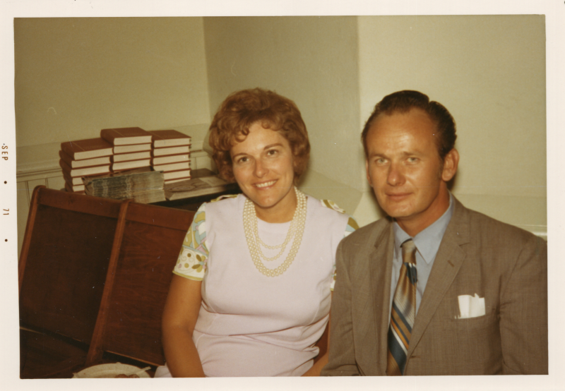 A man and woman smile together for a portrait