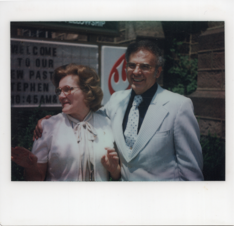 Pastor and Mrs. Bogdan smile in front of the church marquee welcoming them to the pastoral role