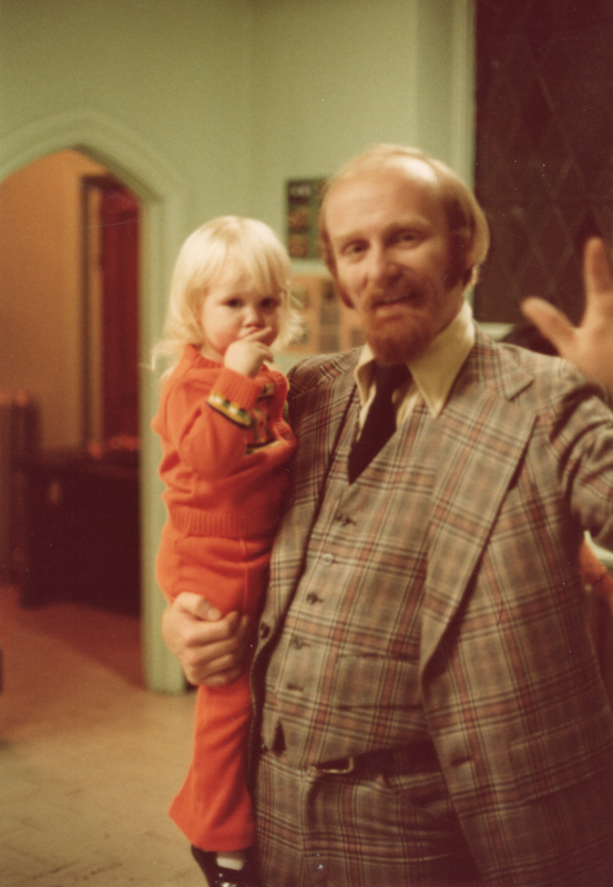 A man holds a small child for an image