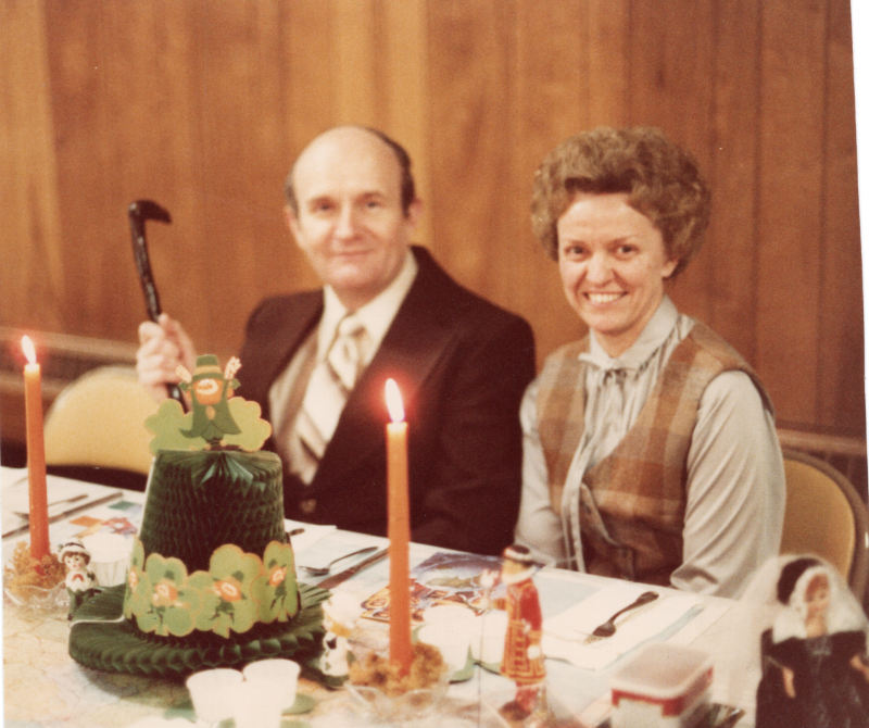 A man and woman smile together for a portrait