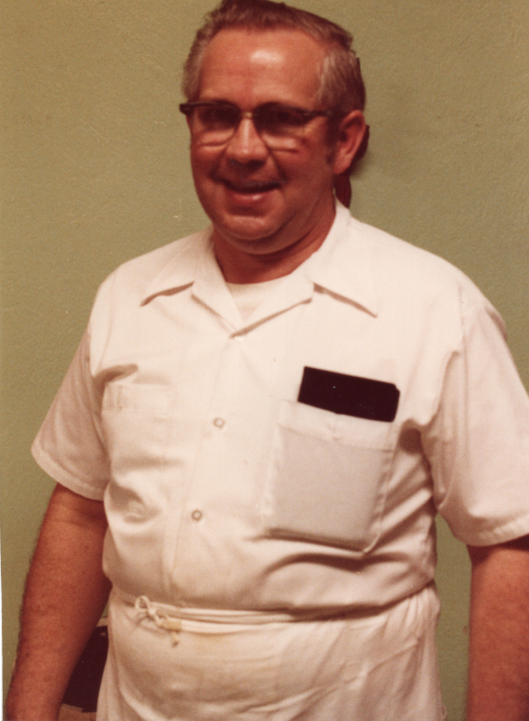 A man smiles for a portrait