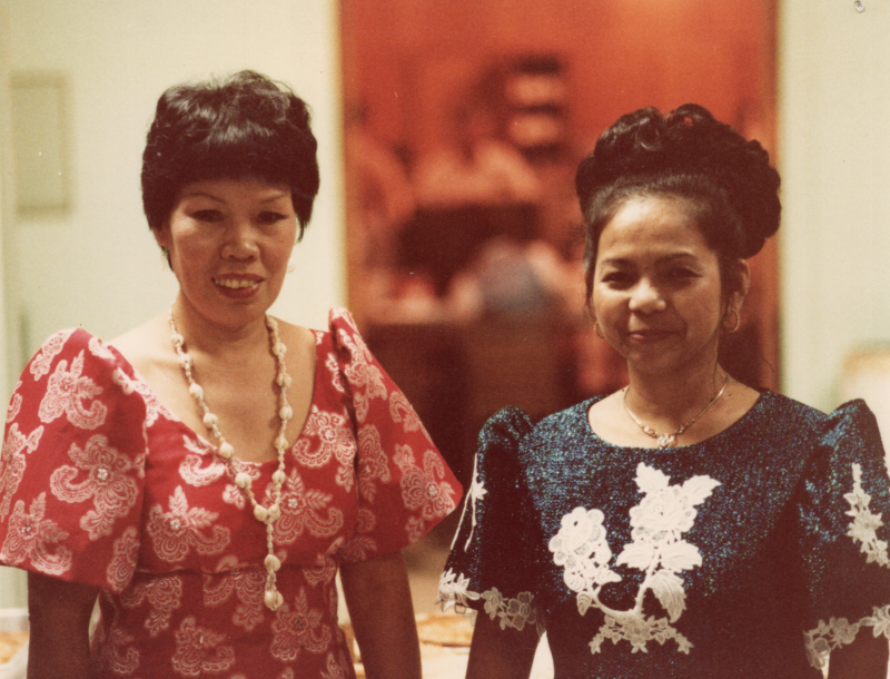 Two women smile together for a photograph