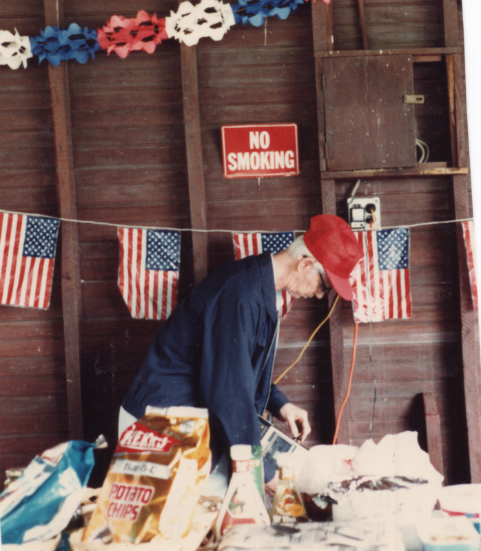 A man prepares a spread of potato chips with America-themed decorations