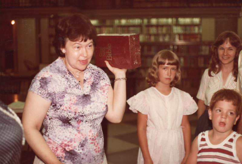 A woman leads VBS with a large-print Bible at the Free Library of Philadelphia Central Branch