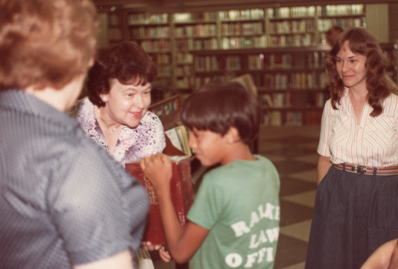 A woman leads VBS with a large-print Bible at the Free Library of Philadelphia Central Branch