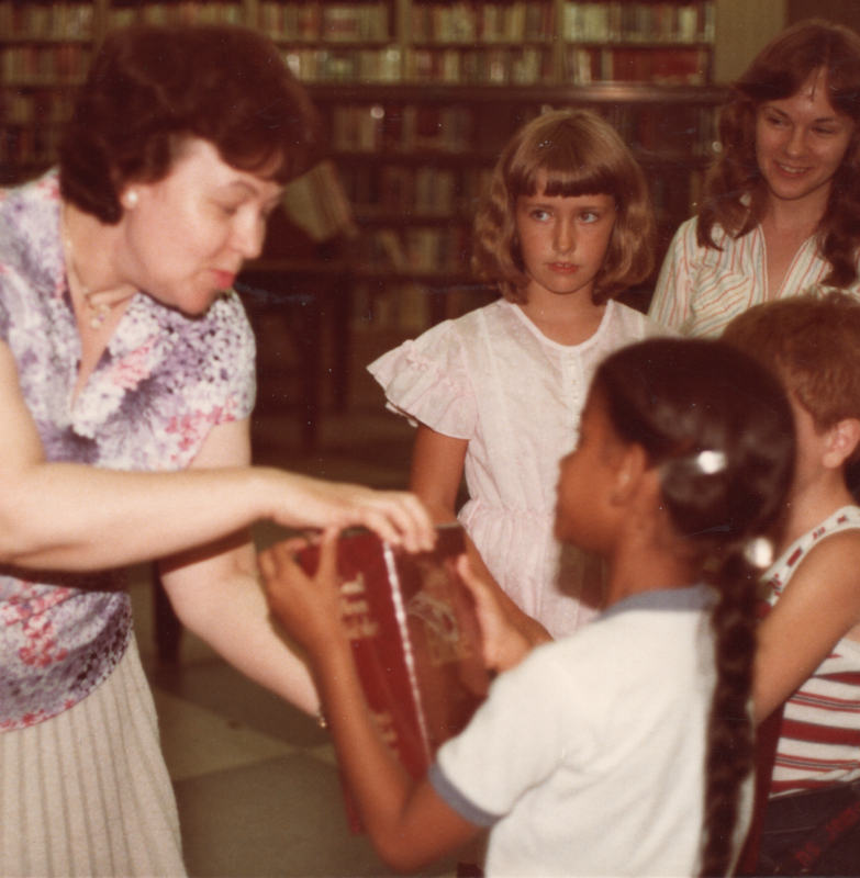 A woman leads VBS with a large-print Bible at the Free Library of Philadelphia Central Branch